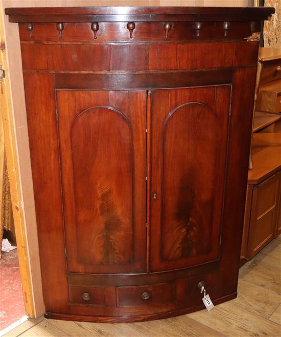 A George III mahogany bowfront corner cupboard W.90cm